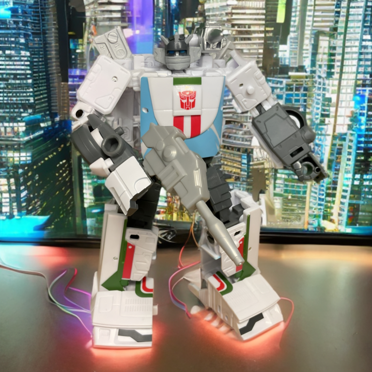 Transformers Studio Series Wheeljack action figure with his signature green and red racing stripes and ear-fin lights.