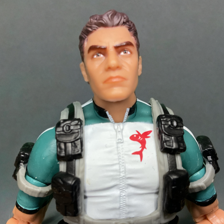 Extreme close-up of the Wet-Suit action figure’s head sculpt showing the detailed facial hair and blue eyes.