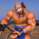 A dramatic image of Beast Man standing triumphant and wielding his whip.