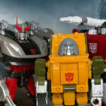 Bluestreak, Brawn, and Sideswipe standing in front of war torn city.