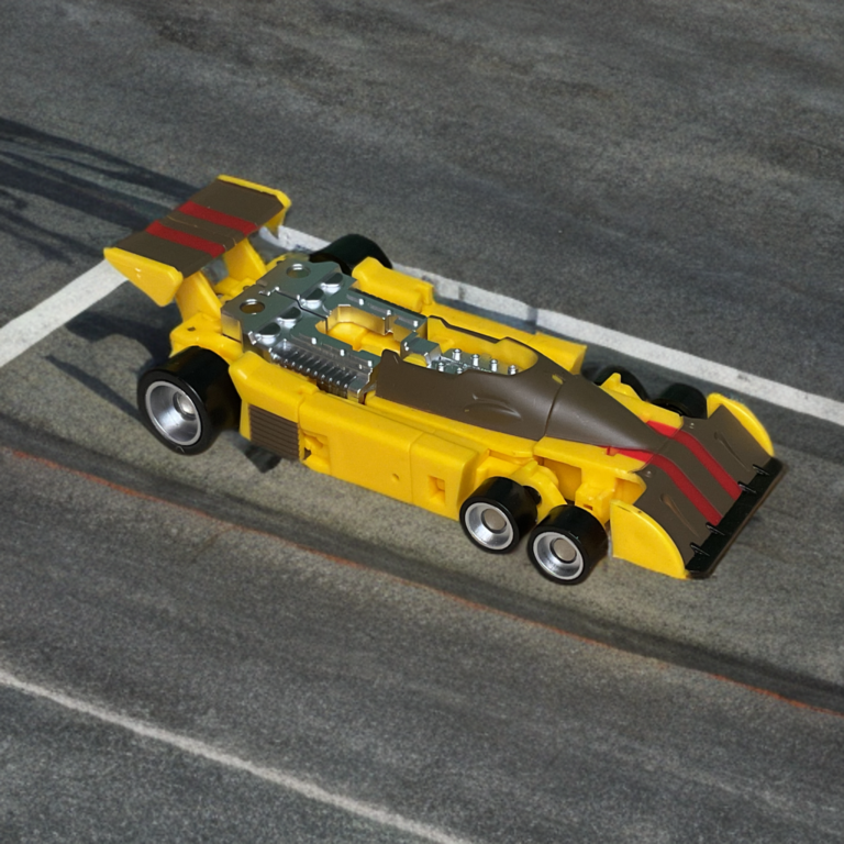 Drag Strip Transformers G1 yellow Formula One race car alt mode, six-wheeled Tyrrell-inspired vehicle.