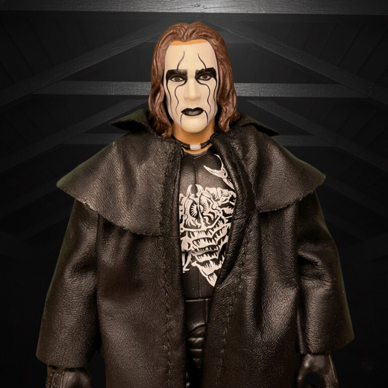 Sting Crow Actionfigur in schwarzem Mantel und weißer Gesichtsbemalung, die in den Dachsparren lauert.