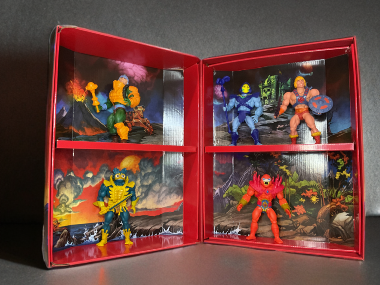 Open carrying case showing Lords of Power figures posed dynamically inside a vintage-style tray.