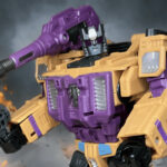 Transformers G1 Swindle action figure in robot mode, yellow and purple Decepticon arms dealer with sly expression.