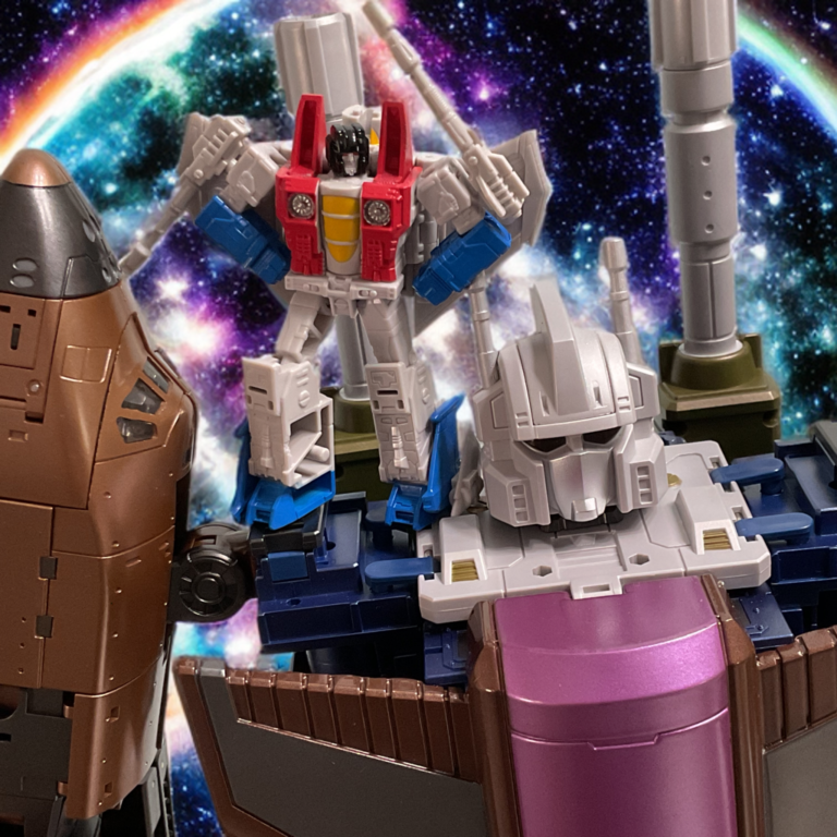 Large combiner robot toy with a smaller Decepticon figure standing on its shoulder, showcasing scale difference against a space nebula background.