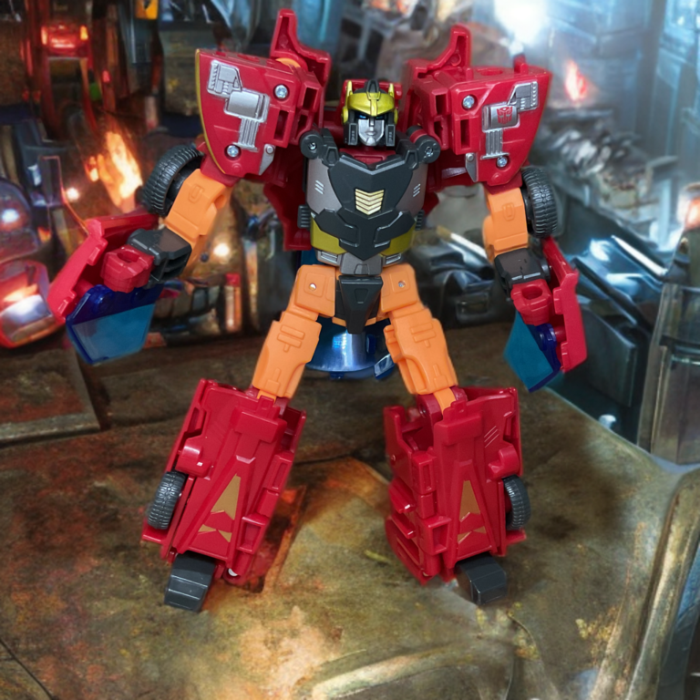 Age of the Primes Excellion robot mode standing pose displaying full height, red torso, orange limbs, and gold flame detailing.