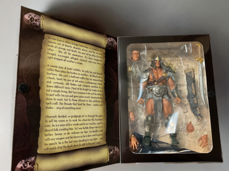 Savage Crucible Krieger The Shunned action figure still in packaging tray unboxing view, secured with accessories, from Fantasy Action Figures review.