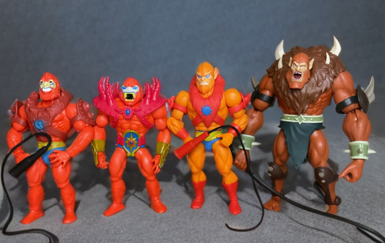 Comparison of 200x Cartoon Collection Beast Man next to the three other Origins versions highlighting design updates.