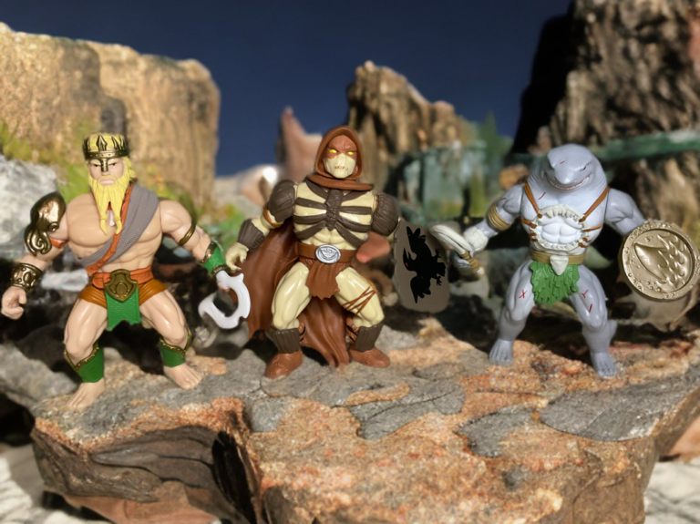 Funko Savage World DC Primal Age action figures, primal-age versions of Batman, Superman, Wonder Woman, and other DC heroes in MOTU-scale barbarian style