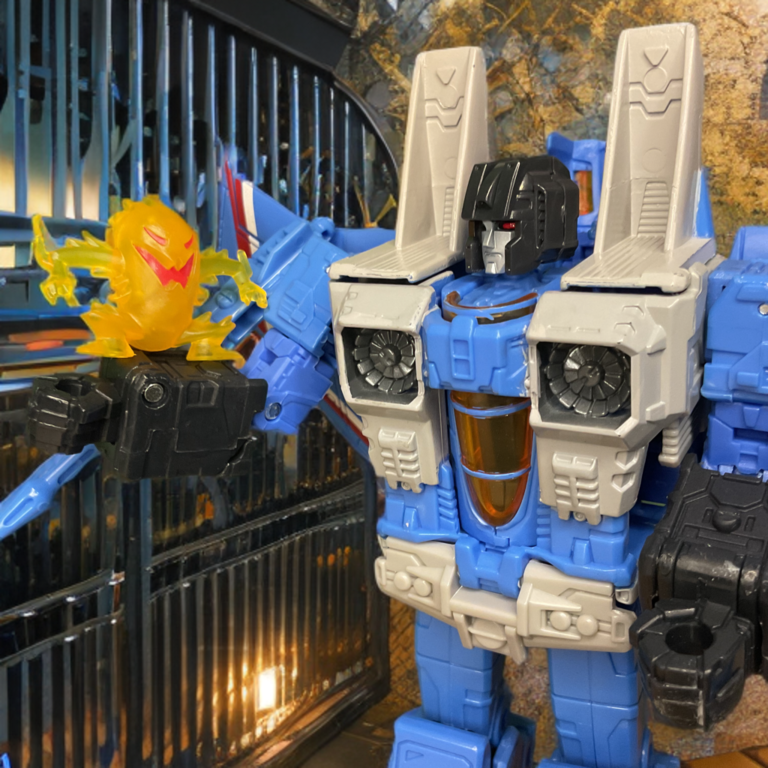 Thundercracker sits Kremzeek on his forearm.