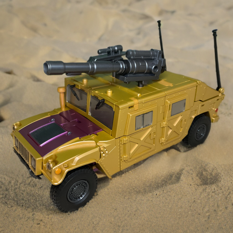Zeta Toys Racket vehicle mode side profile, showing tan body, black roof-mounted artillery, antennas, and rugged off-road tires against neutral background.