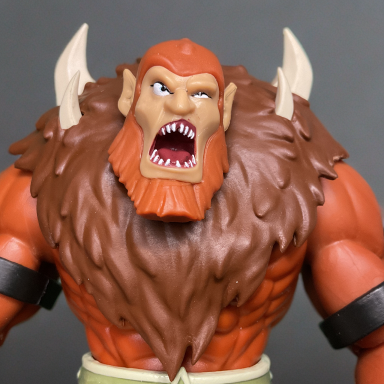 Close-up of Beast Man 200x Cartoon Collection head with bared fangs, scowling face, and detailed wild orange mane.