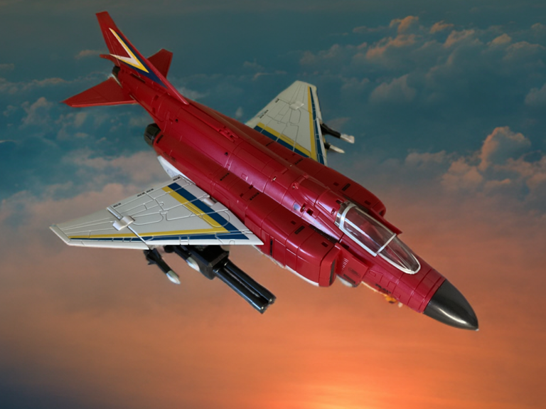 Side view of Zeta Superitron Metallic Fly Fire in F-4 Phantom reconnaissance jet mode, glossy metallic red finish and detailed wing structure.