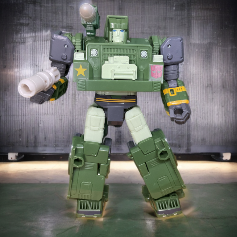 Autobot Hound Studio Series figure with shoulder cannon attached, dynamic pose emphasizing scout functionality.