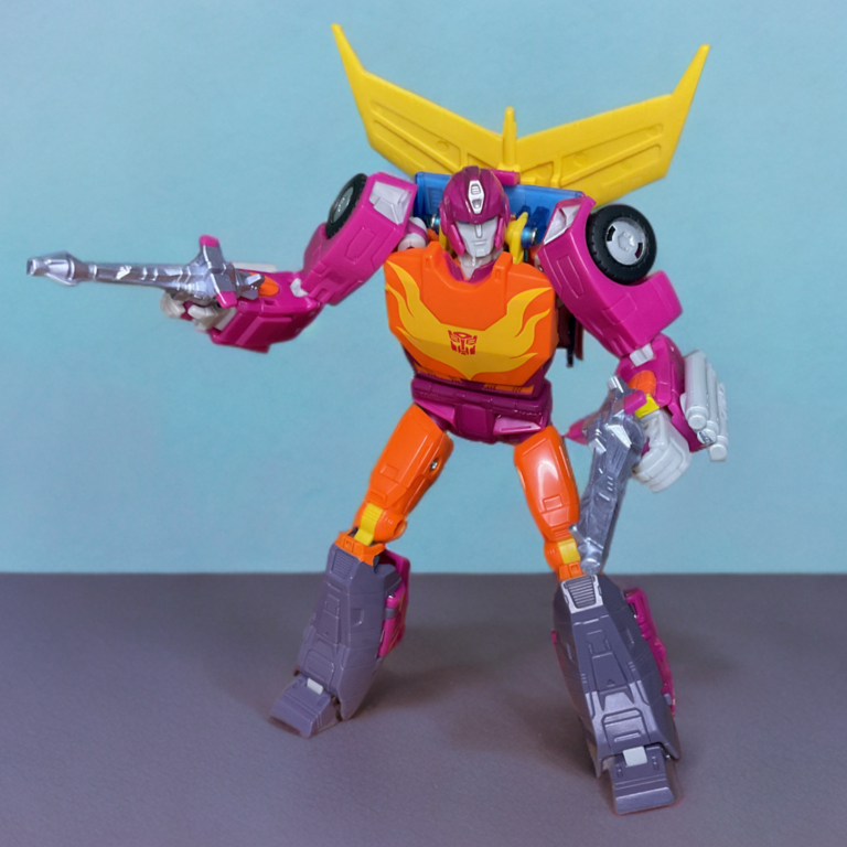 Close-up of Studio Series Hot Rod holding twin Photon Lasers, deep grey weapons against vibrant magenta armor.
