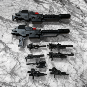 A collection of five different black and silver toy robot guns from the Demon Knight Defensor set.