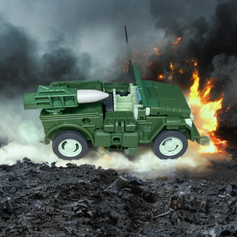 Transformers Studio Series Autobot Hound in Jeep vehicle mode, green military style with blue windshield and star emblem.