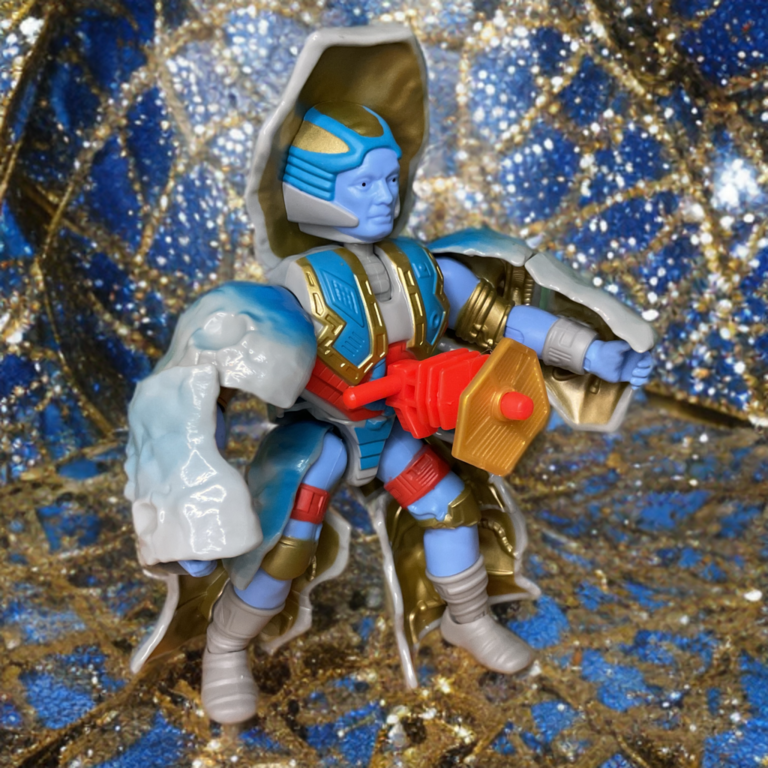 A Fantasy Action Figures apresenta Stonedar de Masters of the Universe Origins segurando o acessório blaster vermelho em uma pose de ação.