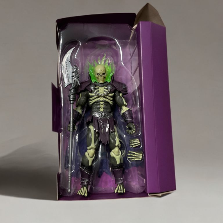 Scare Glow MOTU Chronicles figure in official inaugural edition window packaging, showing the figure and Scythe of Doom inside.