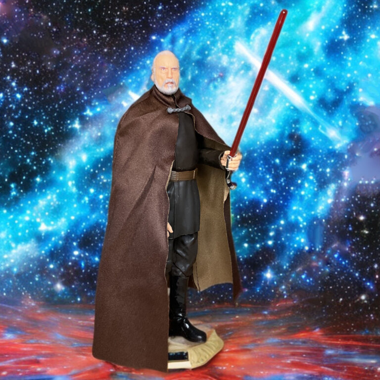 Close-up of the silver and gold curved lightsaber hilt held in Dooku's right hand.