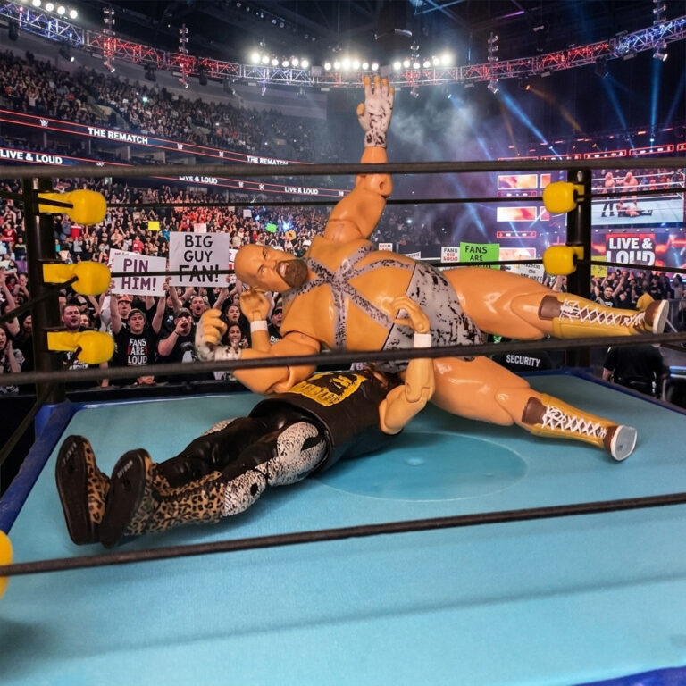 Norman the Lunatic action figure hitting an elbow drop on Cactus Jack Manson.