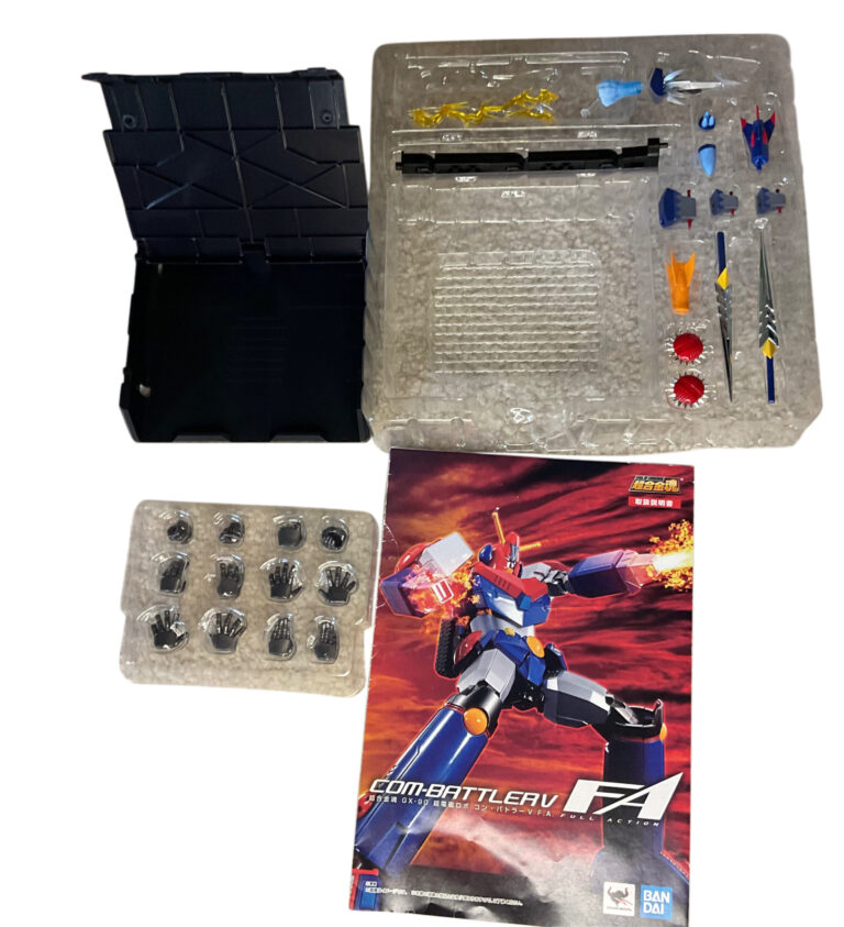 A complete overhead layout shot of all weapons, swappable hand joints, chrome twin lancers, energy effect parts, and the display base included with the GX-90 super robot figure.