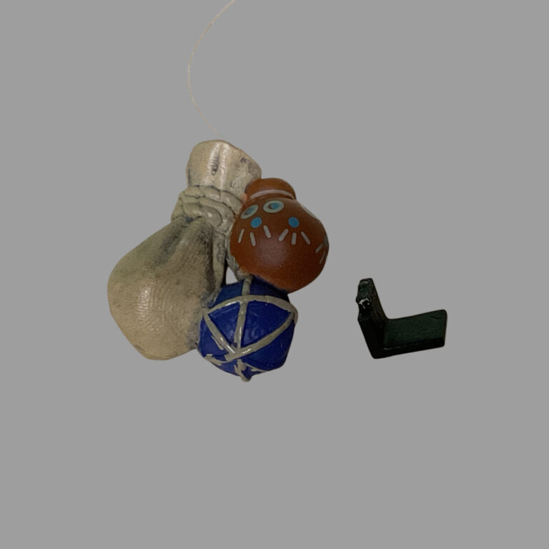Close-up of the broken thin plastic clip on Samir’s belt used for attaching potion bags.