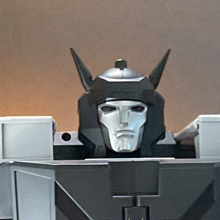 Macro headshot of DX9 Attila Menasor showing the light-piping effect illuminating the translucent red visor mask.
