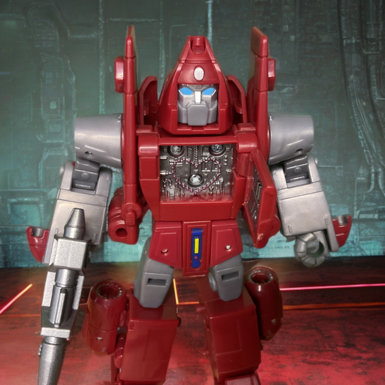 Close-up of the Powerglide action figure's chest panel flipped open, revealing the small molded heart element inside.