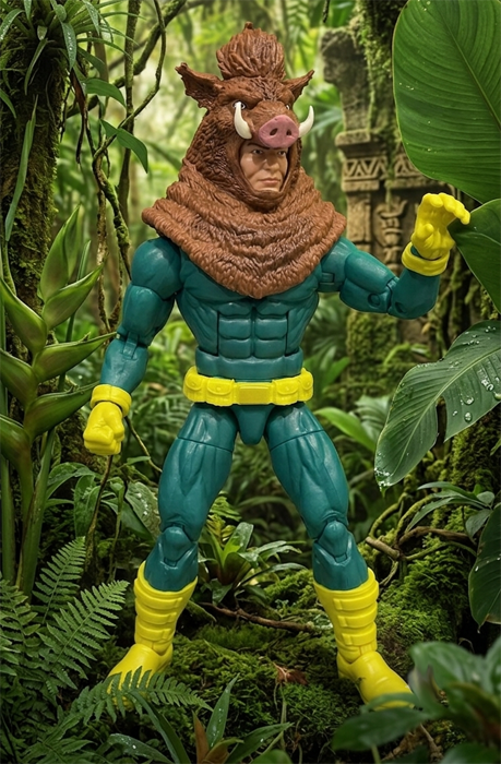 Close-up of a Razorback action figure standing in a dense, mossy jungle surrounded by green tropical ferns, broad leaves, and vines. The figure wears a dark teal muscle suit with a yellow belt and boots, topped with a detailed brown wild boar headpiece featuring white tusks and a pink snout.
